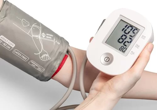 A blood-pressure monitor cuff being fitted to a patient's arm